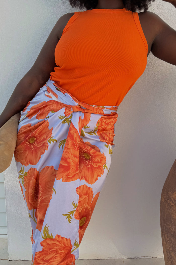Iconic Blue Poppy Jaspre Skirt with orange floral print and wrap tie fastening on a size 16 model.