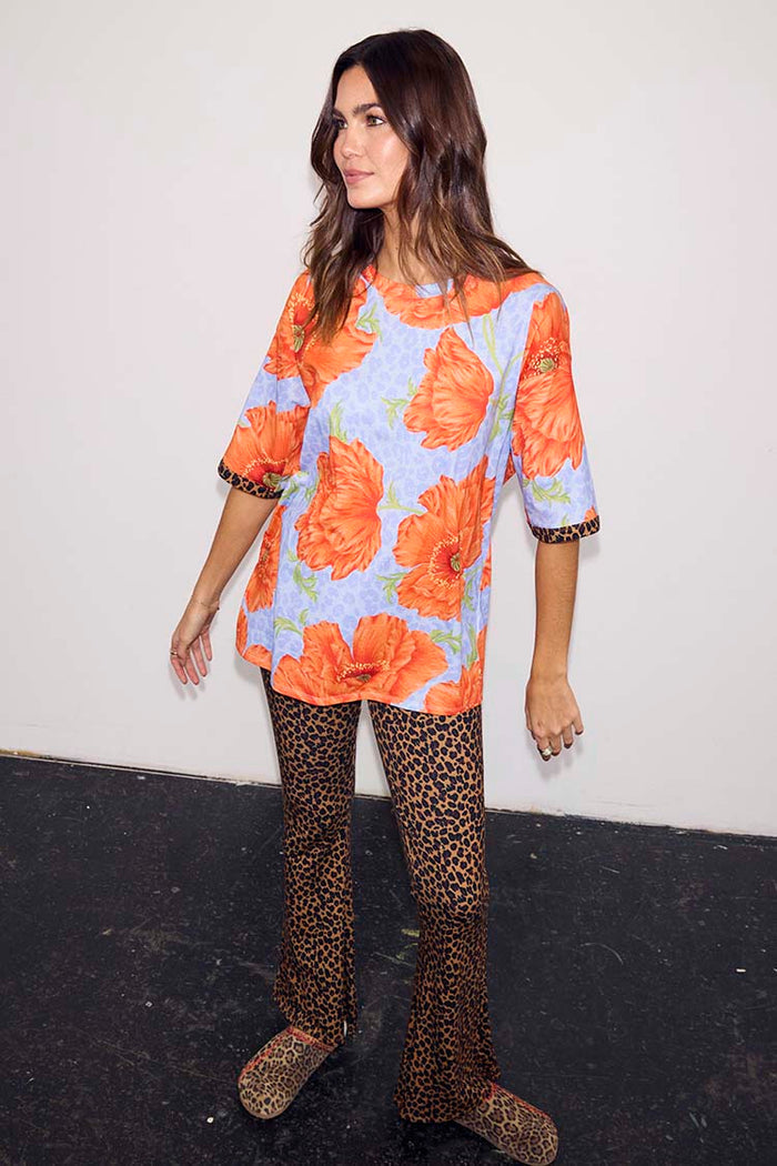Blue Poppy Print Jersey Pyjamas with orange poppies, leopard print cuffs and matching leopard print flare trousers.