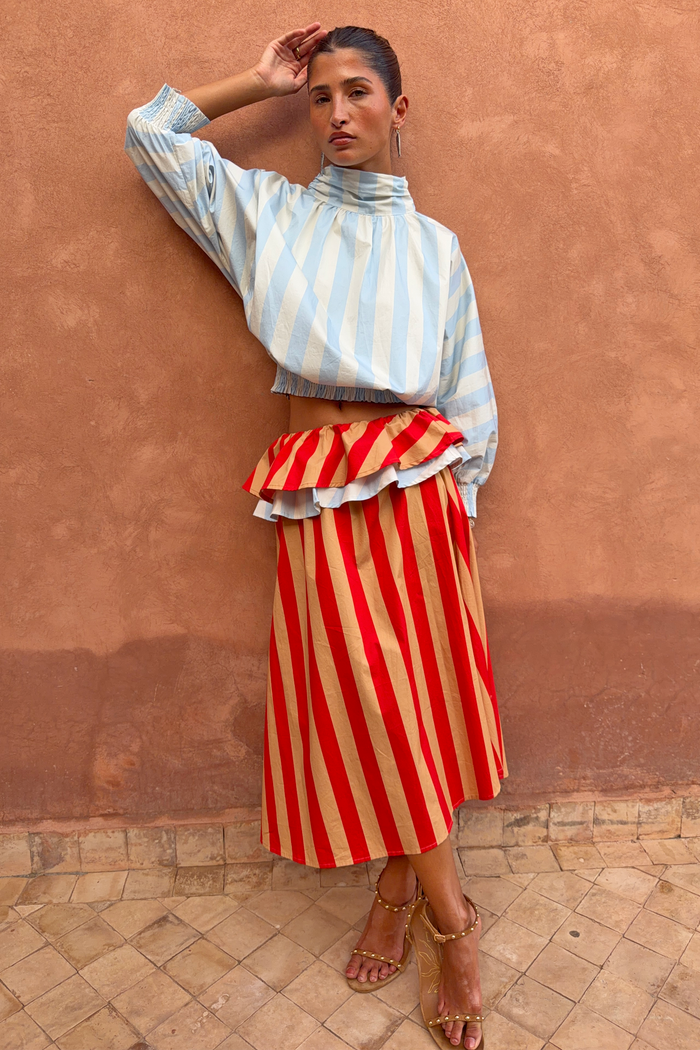 Blue Stripe Batwing Blouse with shirred cuffs and a smocked waist, paired with a red striped ruffled skirt.
