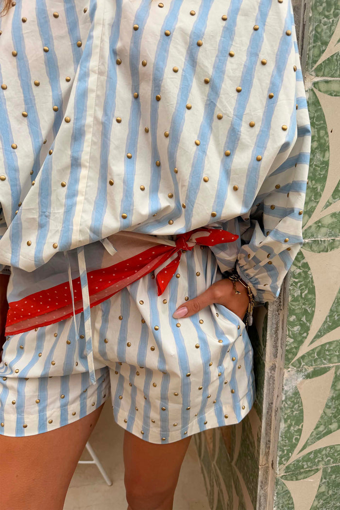 Blue Stripe Ellie Short in cotton with gold studs, styled with a matching shirt and red scarf waist tie.