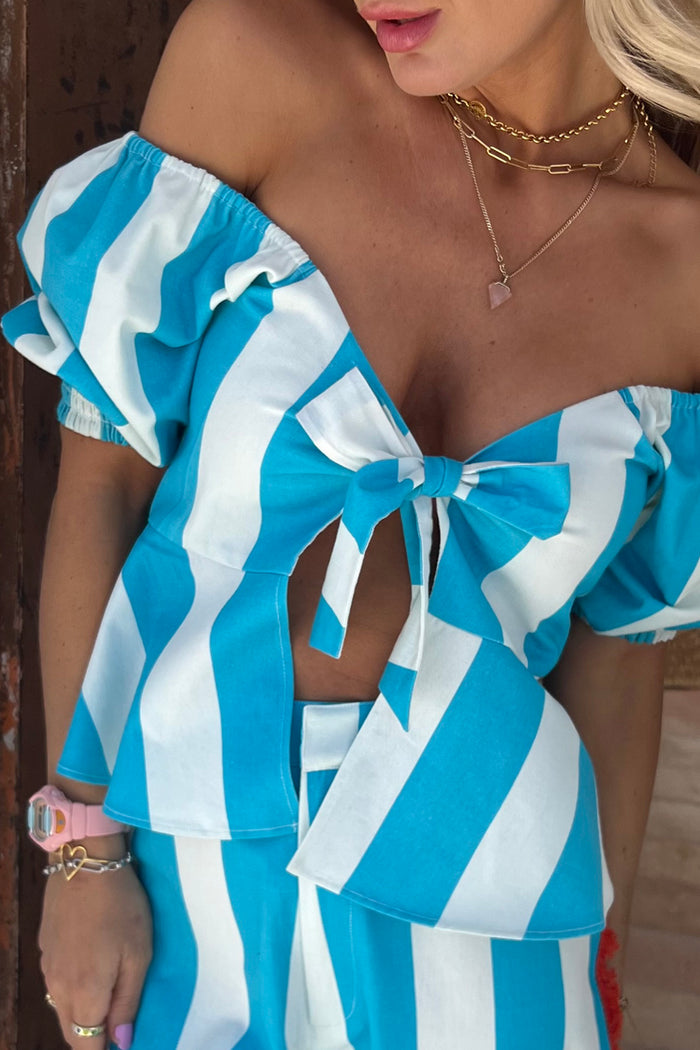 Blue Stripe Kiki Top with off-the-shoulder puffed sleeves and a front-tie peplum detail.