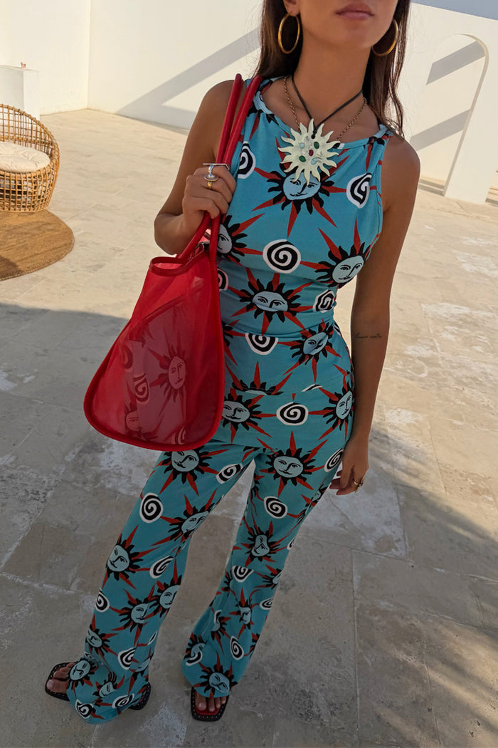 Blue Sun Foldover Trousers in a bright blue sun and swirl print, styled as a flared jersey co-ord for a summer look.