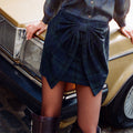Blue Tartan Bow Skirt in a green check wool blend with a large bow, styled with a matching shirt and vintage car.