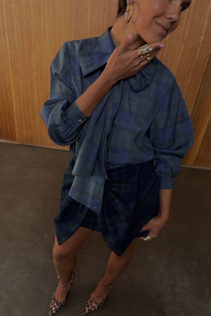 Blue and green tartan wool mini skirt and matching bow shirt styled with leopard print heels.