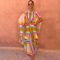 Bright Geo Stevie Maxi Dress with cape sleeves and a colourful geometric print, ideal for vacation evenings.