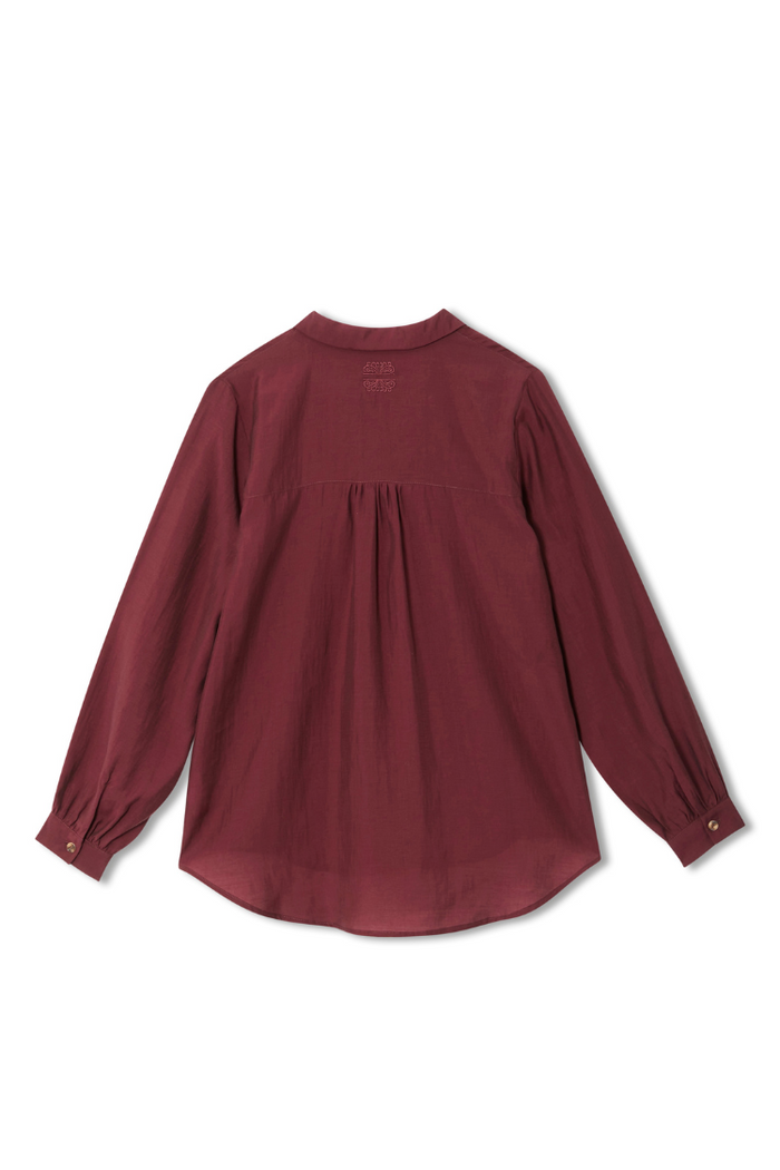 Burgundy Ruffle Miley Shirt in wine showing back detailing, blouson sleeves and an embroidered logo on the neck.