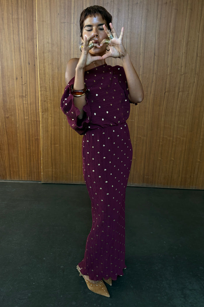 Burgundy Tilly Dress in plisse with gold flecks, featuring a multi-wear off-the-shoulder neckline.