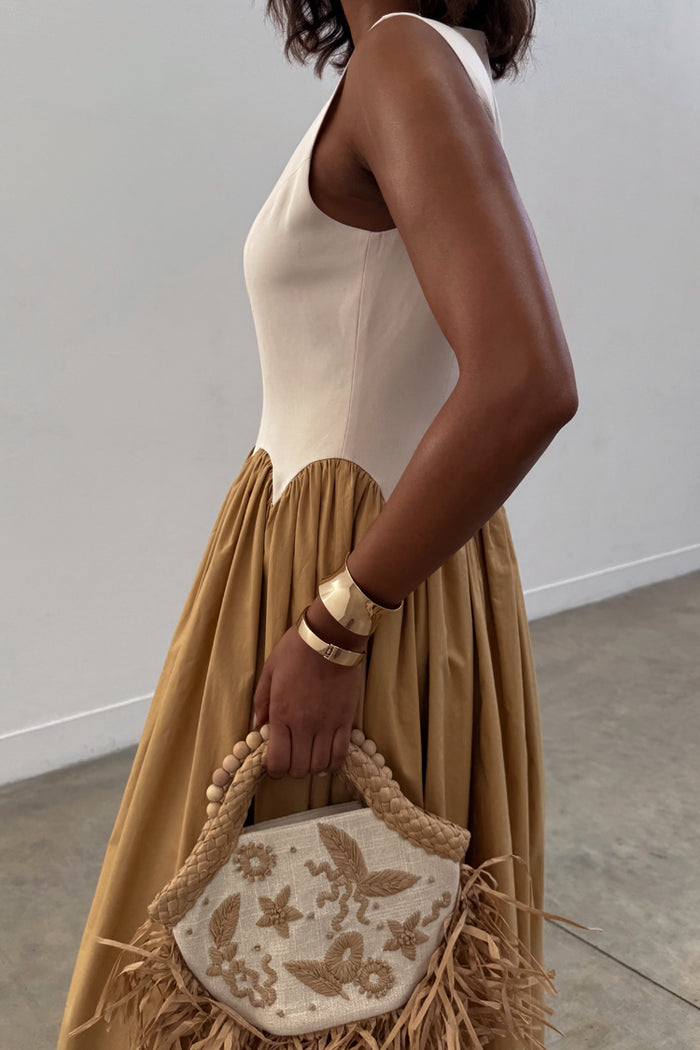 Camel Monika Midaxi Dress with a cream corset-style bodice, scalloped edging and a pleated camel-coloured skirt.
