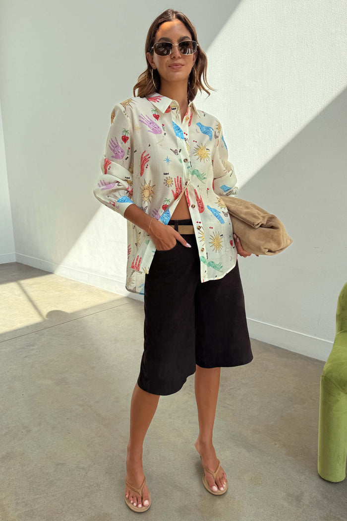 Cream Celestial Marley Shirt in an oversized fit with colourful palm, heart and sun prints, styled with black shorts.