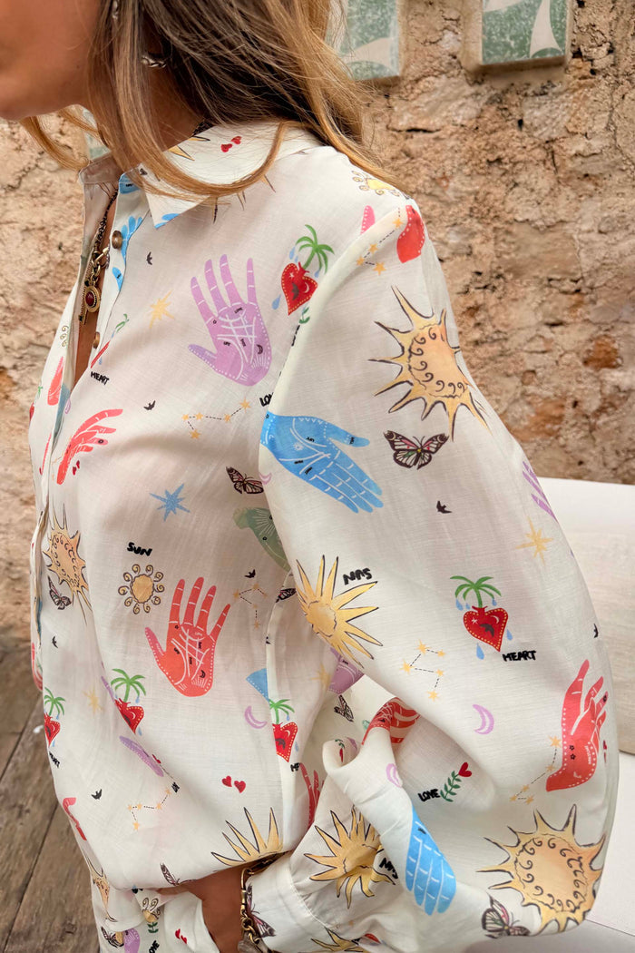 Celestial Marley Shirt in cream with a colourful sun and palm print in a slightly sheer, lightweight fabric.