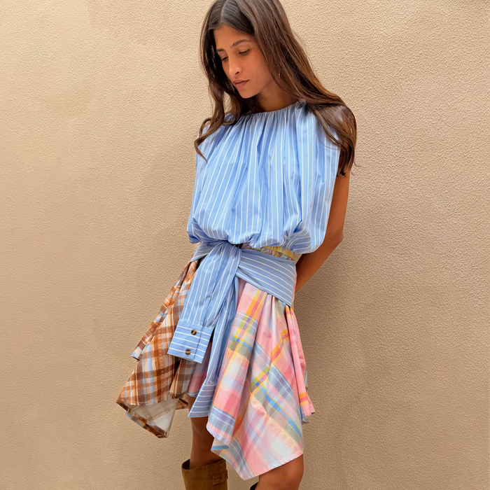 Check Asymmetric Mini Skirt featuring a mixed print hanky hem and blue striped waist tie detail on a model.