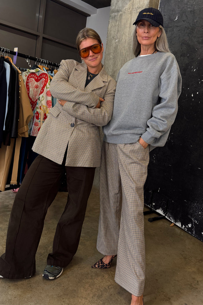 Grey Check Trousers styled with a sweatshirt and leopard print heels for a smart casual London look.