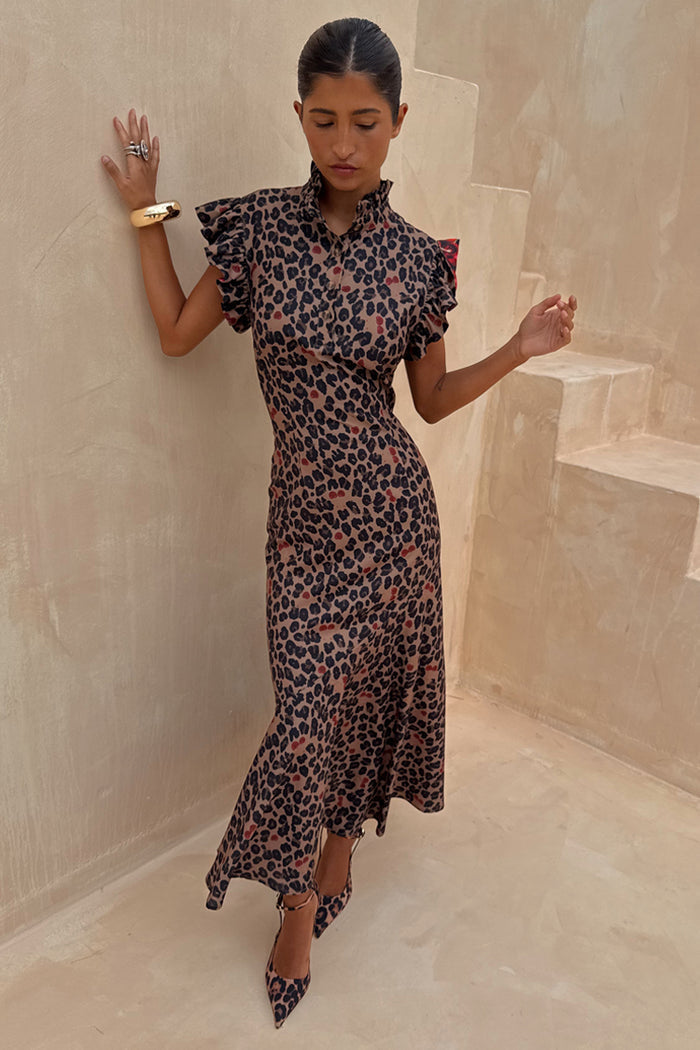 Cherry Leopard Remi Dress with a high neck, pleated frills and an asymmetrical skirt on a model.