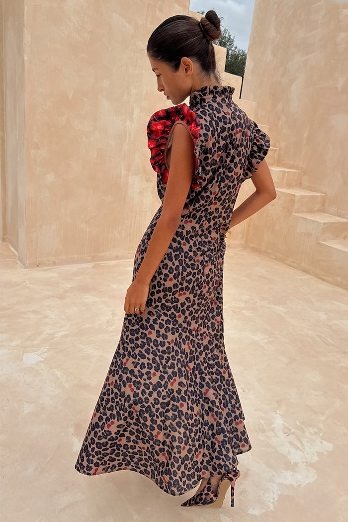 Cherry Leopard Remi Dress featuring red pleated frill sleeves and iconic leopard print, styled with matching heels.