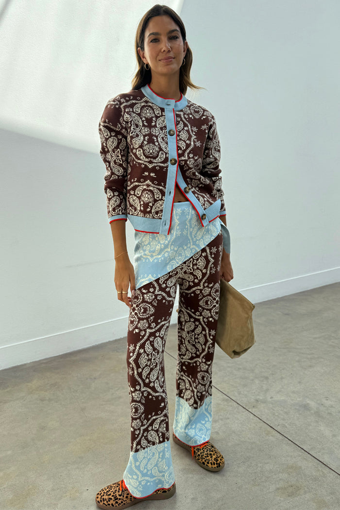 Chocolate Bandana Wide Leg Trousers with an iconic print and blue hem, styled with a matching cardigan co-ord.