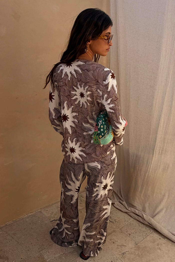 Ribbed Chocolate Soleil Alexa Cardigan in a brown sun print, styled as a co-ord with matching trousers.