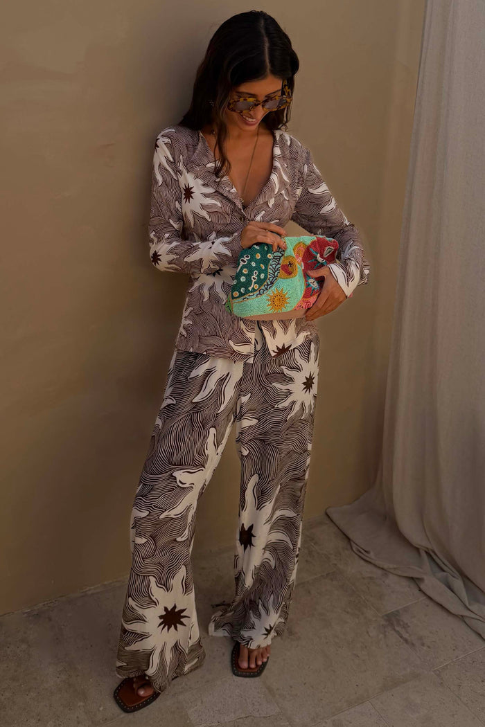 Chocolate Soleil Ellie Trousers and Alex Cardigan co-ord featuring a sun motif print and line detailing.