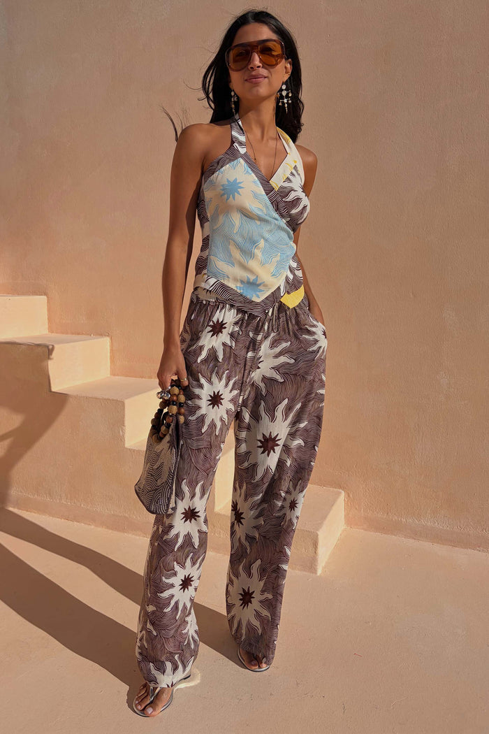 Chocolate Soleil Ellie Trousers with a brown sun motif print and wide-leg fit, styled as a summer co-ord.