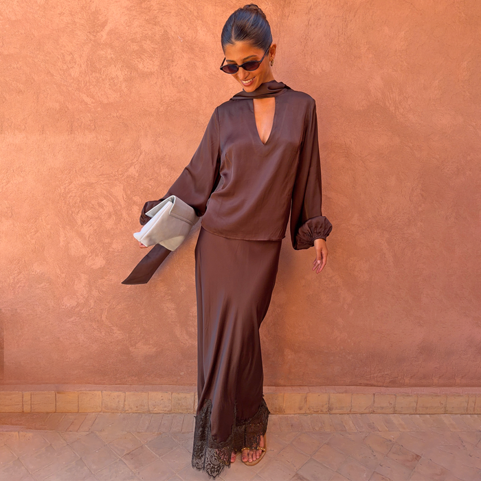 Chocolate Tie Neck Blouse in satin with volume sleeves and multi-wear neckline, paired with a matching lace trim skirt.