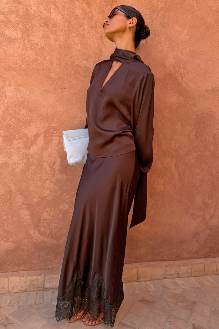 Chocolate Tie Neck Blouse and Maeva Skirt co-ord with a black lace border and a satin-esque finish.