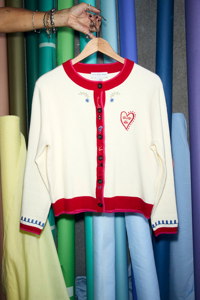 White Choose Love Cardigan in a knit with red trims, heart embroidery and blue cuff details.