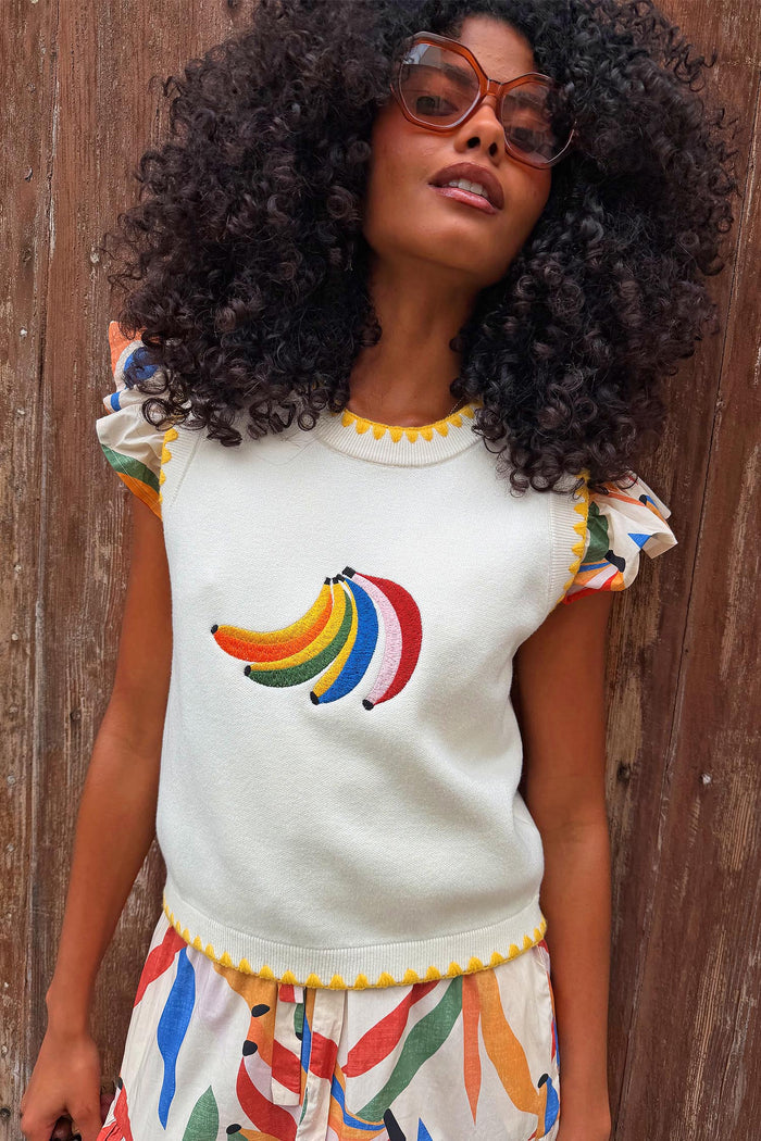 Cream Banana Tank featuring a colourful embroidered banana motif and yellow contrast stitching on a model.