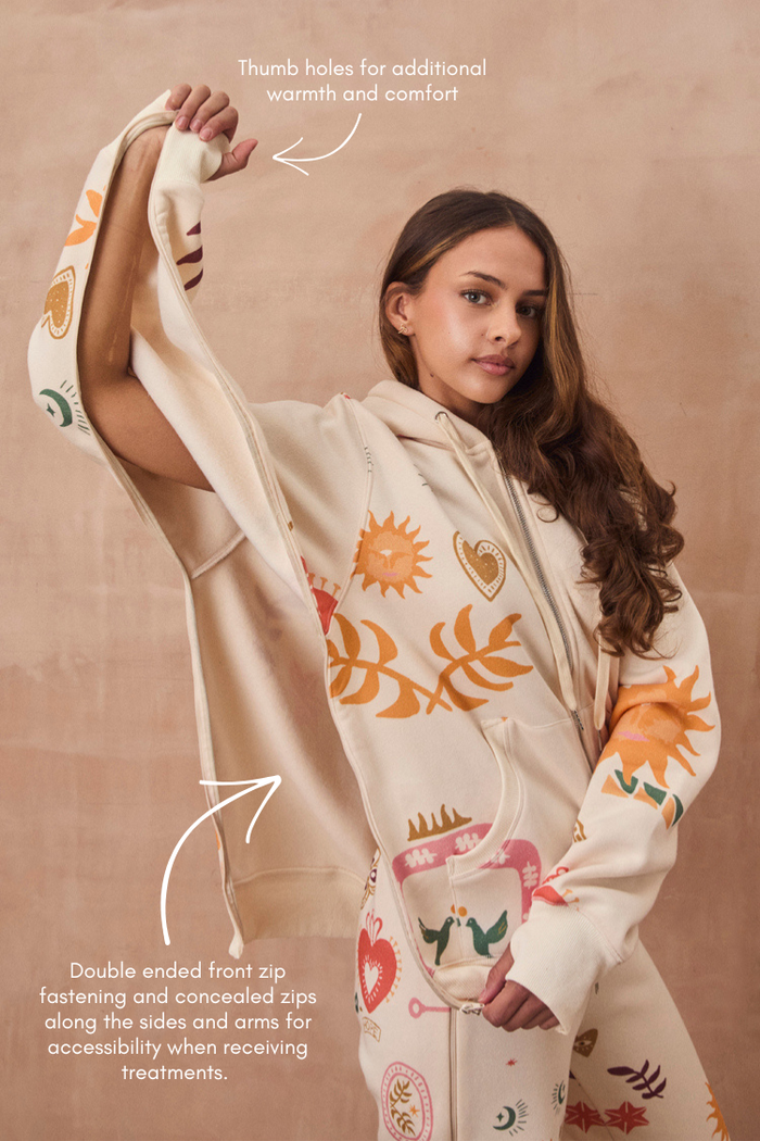 Cream Sundazed Accessible Hoodie featuring sun prints, concealed zips for treatment access, and thumb holes.