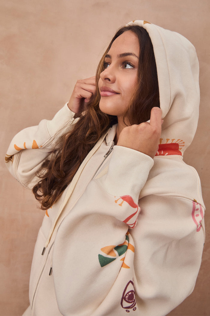 Cream Sundazed Accessible Hoodie with colourful abstract prints, featuring a zip front and drawstring hood.