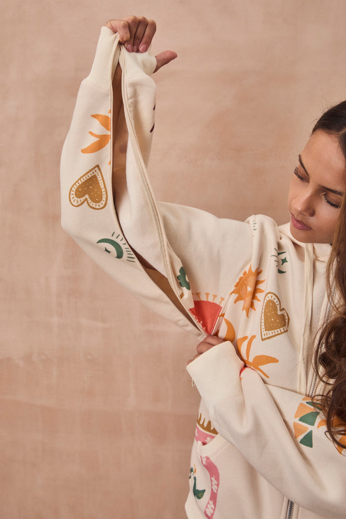 Cream Sundazed Accessible Hoodie with concealed arm zips for treatment access and colourful heart and sun prints.