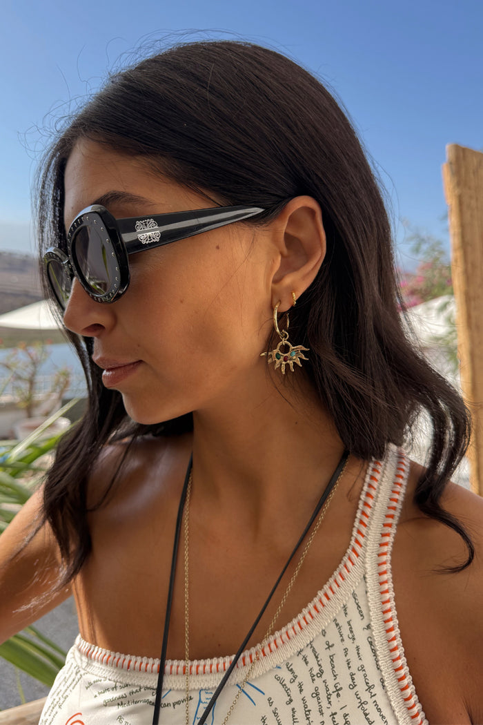 Deloris Sun Hoop Earrings in gold-tone with iconic sun motifs and colourful semi-precious stones, worn on a model.
