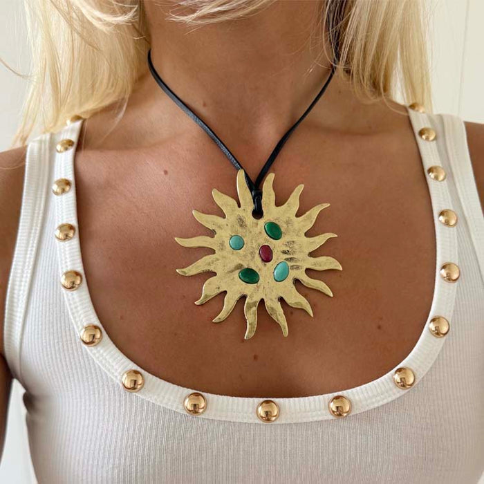 Deloris Sun Necklace in gold brass with inlaid semi-precious stones and a black leather cord tie.