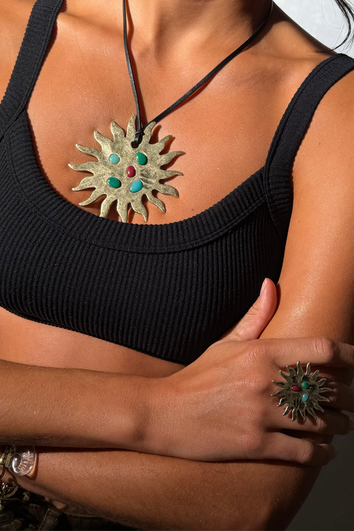 Deloris Sun Necklace in brass with colourful semi-precious stones on a black leather cord tie.