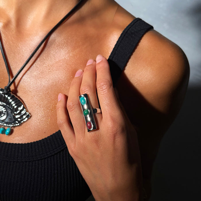 Deloris Whistle Ring with turquoise, green and red gemstones in a chunky polished design, designed in London.