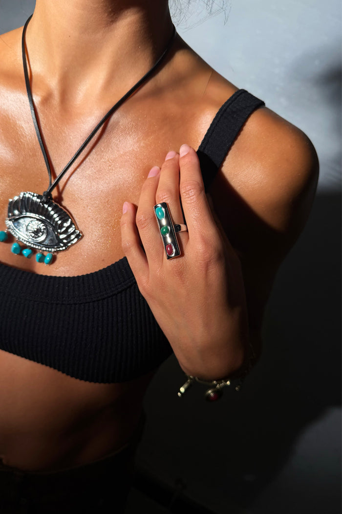 Deloris Whistle Ring in chunky silver-toned brass with three colourful gemstones on a model.