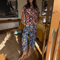 Denim Paisley Barrel Leg Jeans in blue with a pink and teal print, styled with a patterned top and heels.