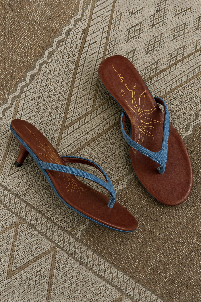 Denim Sandal Mule with slim straps, a low kitten heel and signature sun motif on a brown cushioned sole.