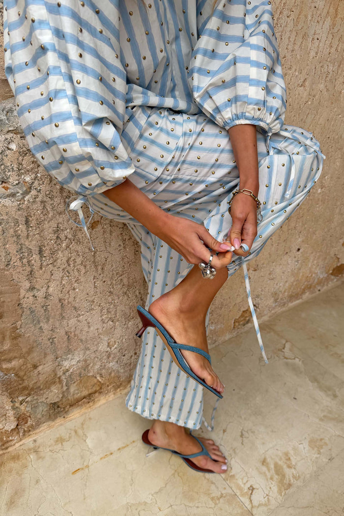 Denim Sandal Mule with slim blue straps and a sculpted kitten heel, styled with a striped co-ord set.