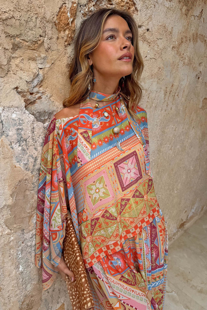 Dolce Vita Cape Top in a pastel patchwork print with wide fluid sleeves and a detachable neck scarf.