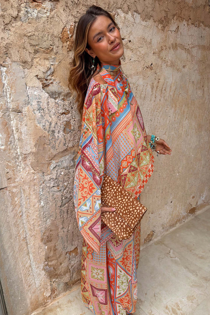 Dolce Vita Cape Top in a pastel tile patchwork print with wide fluid sleeves and a detachable matching scarf.