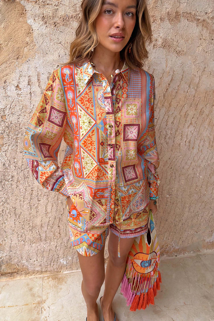 Dolce Vita Ellie Shorts in a colourful tile patchwork print, styled with a matching shirt for a co-ord look.