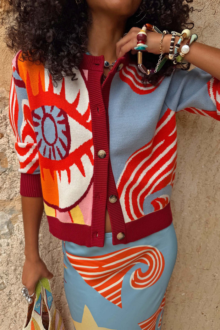Dolce Vita Hollie Cardigan featuring an oversized eye print, swirling motifs and burgundy ribbed trims.