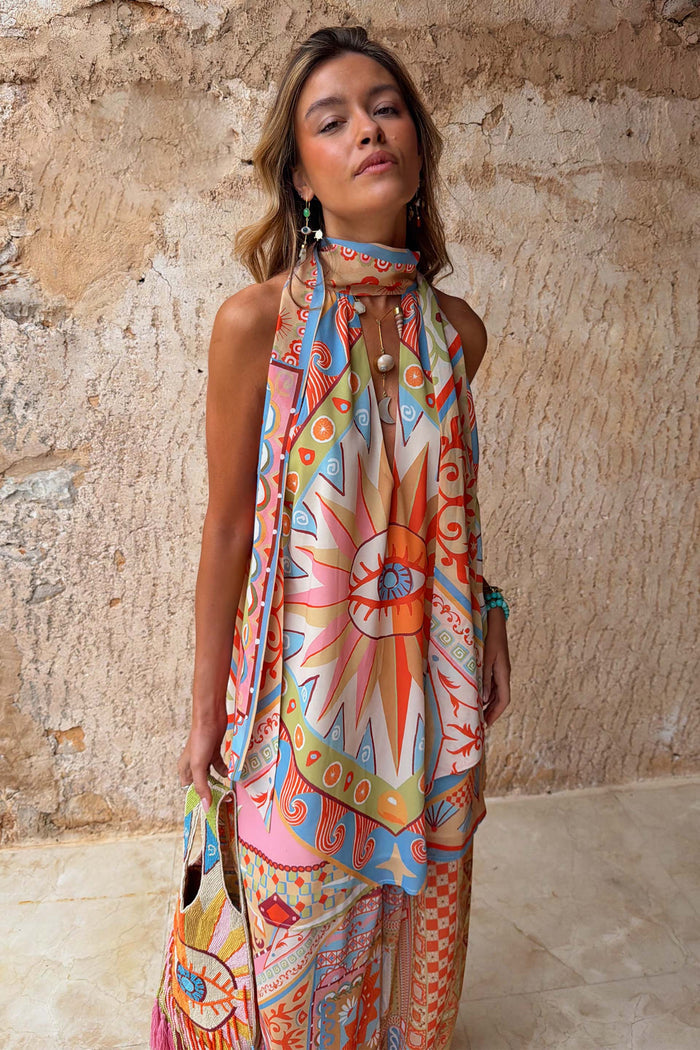 Dolce Vita Josie Mini Dress featuring an iconic eye motif, scarf halterneck and sunset tones.