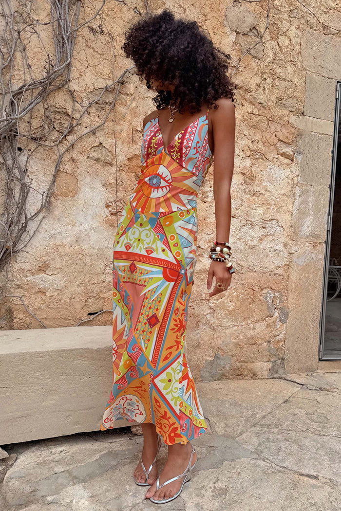 Dolce Vita Valeria slip midi dress featuring sun motifs and a cowl neckline in orange, blue and pink.