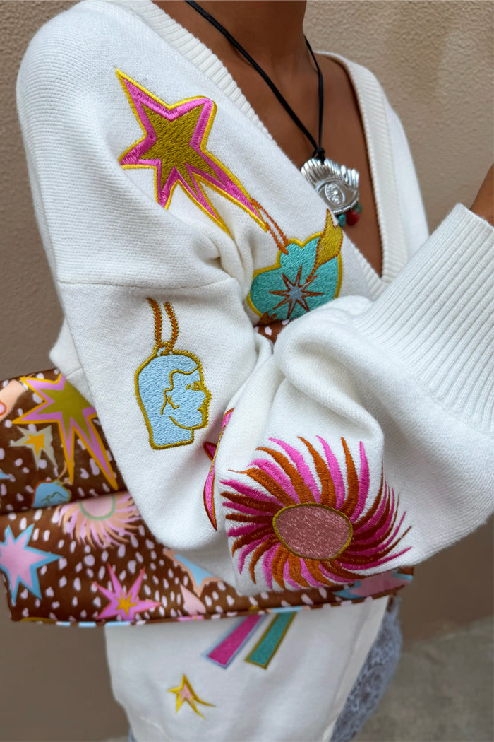 Dreamer Martha Cardigan in cream soft-touch knit with colourful embroidered sun and star motifs and a ribbed cuff.
