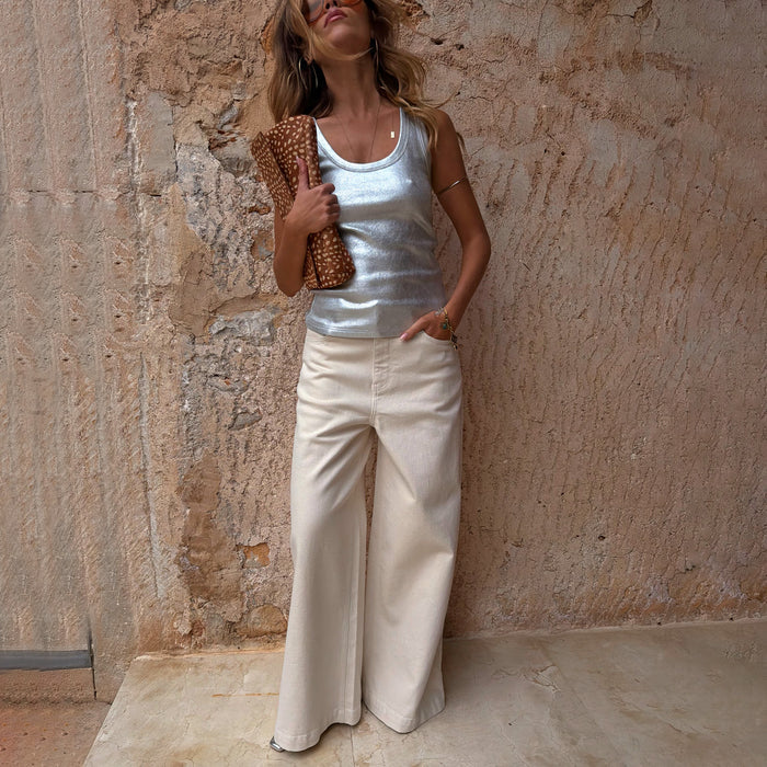 Ecru Jan Jeans with a wide palazzo leg, paired with a silver metallic tank top and leopard print clutch.