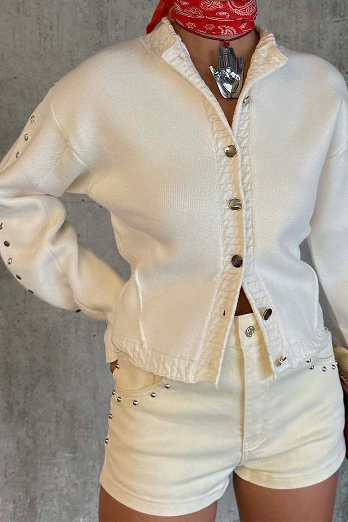 Ecru Studded Cardigan featuring silver studs and twist stitch detailing, worn with matching cream shorts.