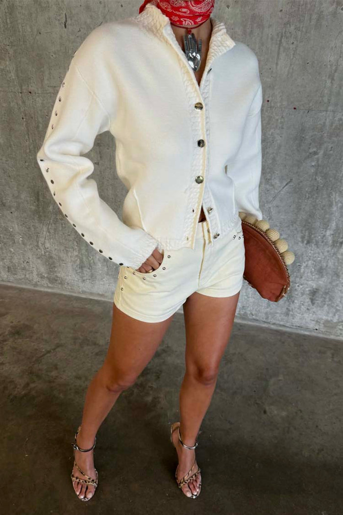 Ecru Studded Cardigan with silver metal sleeve detailing, styled with cream shorts and leopard print sandals.