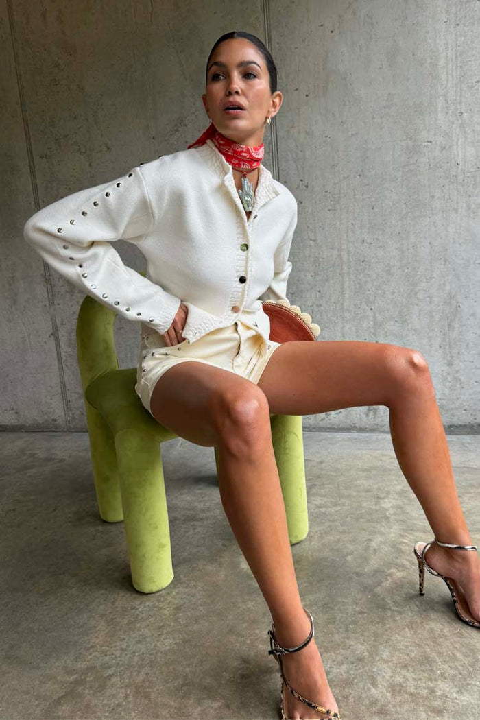 Ecru Studded Cardigan with silver studs on the sleeves, styled with matching shorts for a structured look.