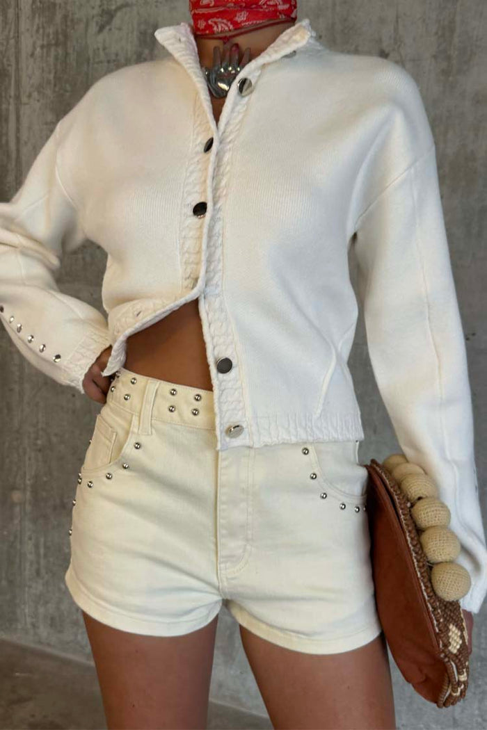 Ecru Studded Hot Pant featuring silver stud detailing on cream denim, styled for a festival look.