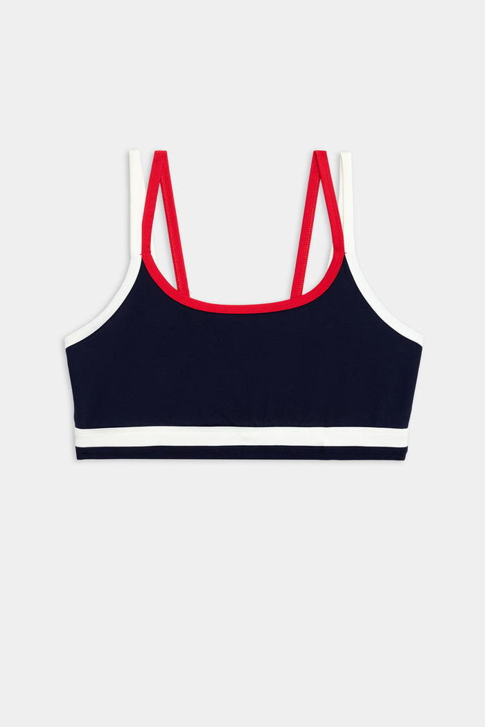 The SPLITS59 Eva Rigor Double Strap Bra in Indigo/White features contrast color accents and double red straps, shown on a plain background—perfect for gym workouts.